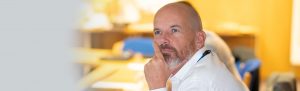 a businessman looking pensive at a meeting